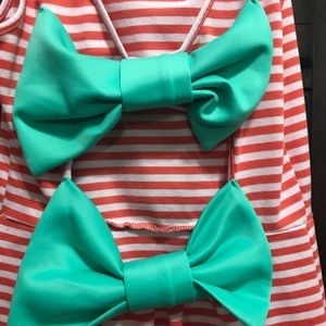 Striped dress with blue bows on back.